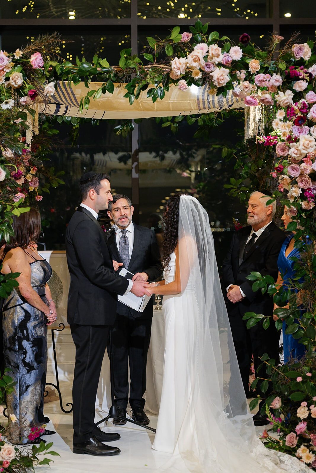 Ceremony under a chuppah of pink and white roses