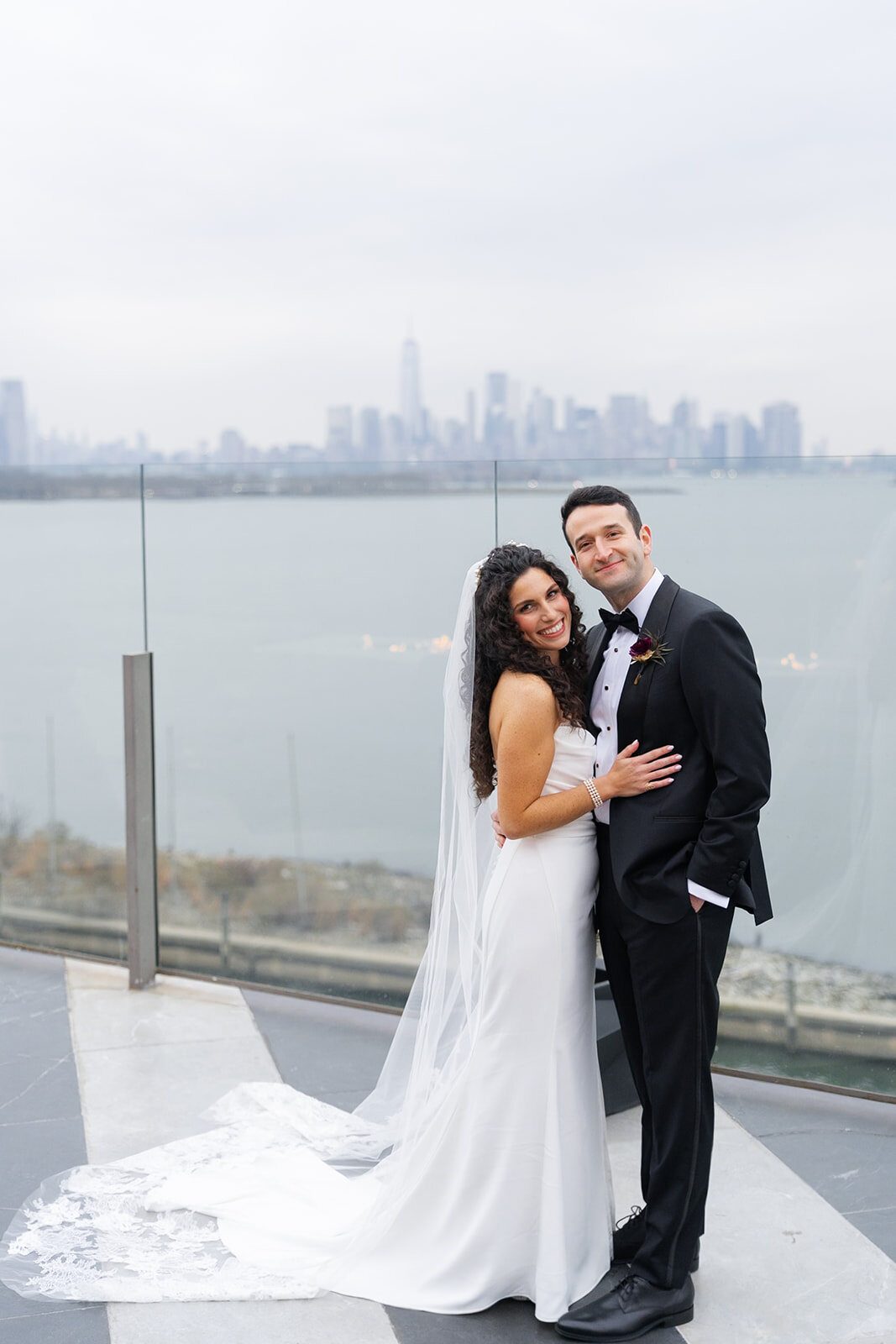 Ellie and Harrison on the terrace with the skyline behind them